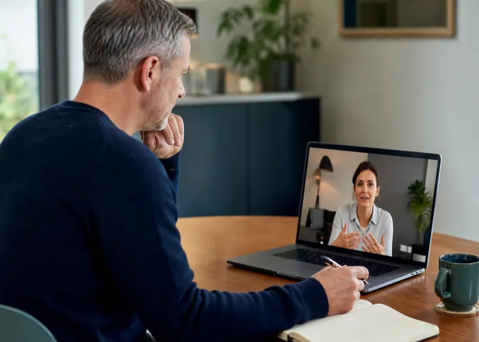 Adult discussing medication and prescribing during an online consultation